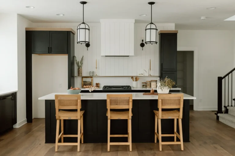 Kitchen with black cabinetry, quartz island and custom range hood in the Callison Cottage at 107 N 36th Street, Cumming