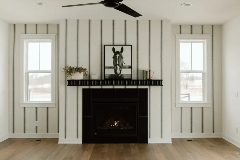 Living room with gas fireplace and board and batten wall in the Callison Cottage