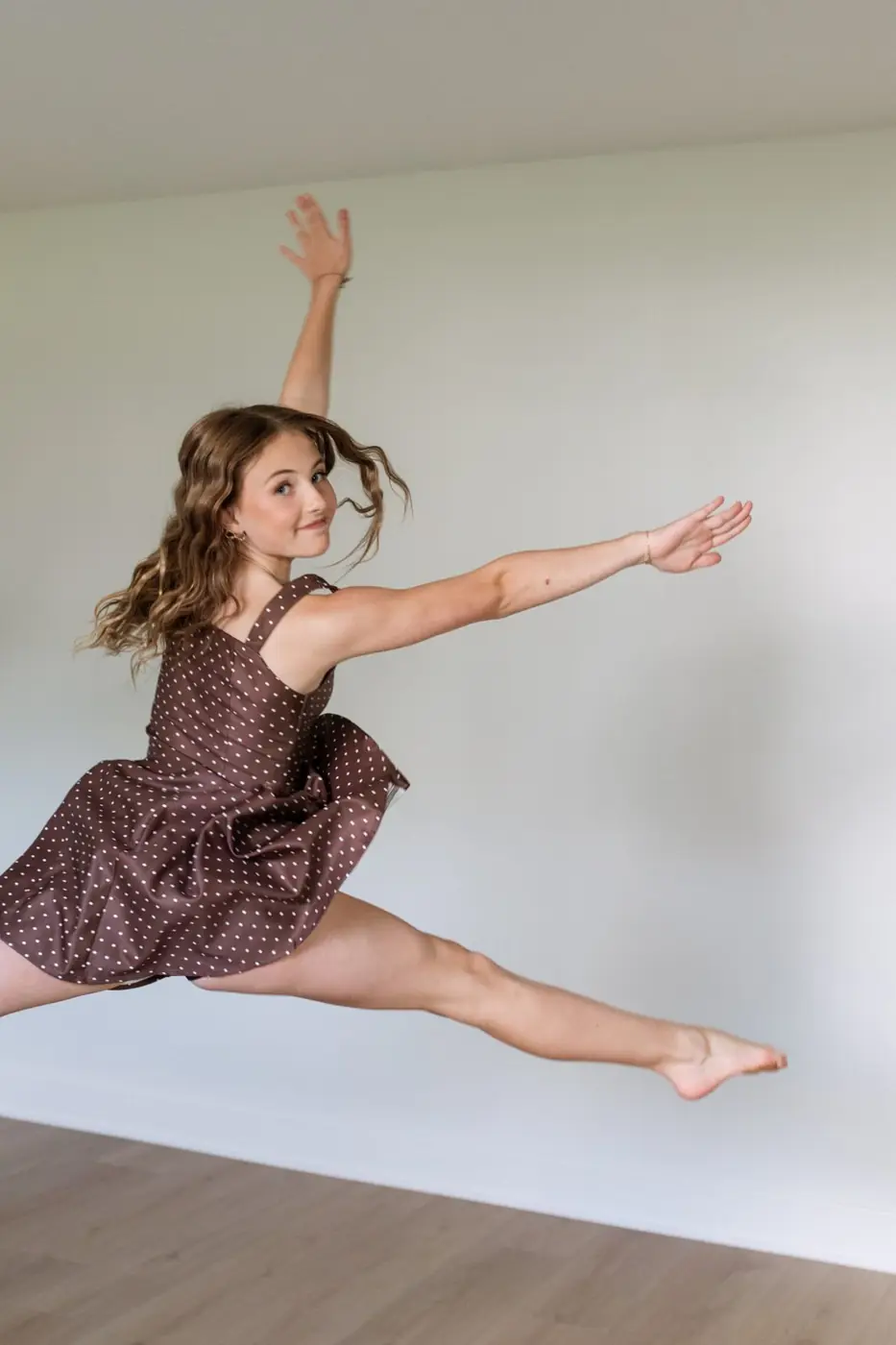 Jules Ludwig mid-leap in the home dance and workout studio