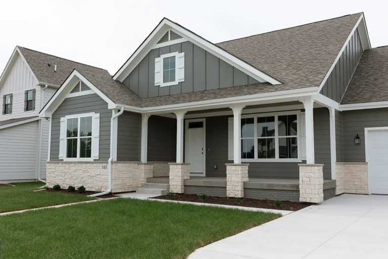 The Warren Craftsman ranch home with stone accents and front porch at 117 N 36th St in Cumming, Iowa
