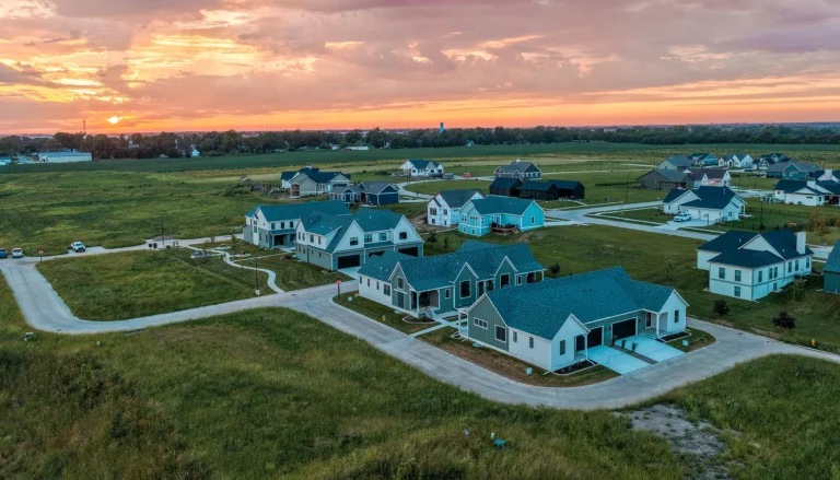 Aerial sunset view of the Homestead ranch townhomes at Middlebrook agrihood in Cumming, Iowa